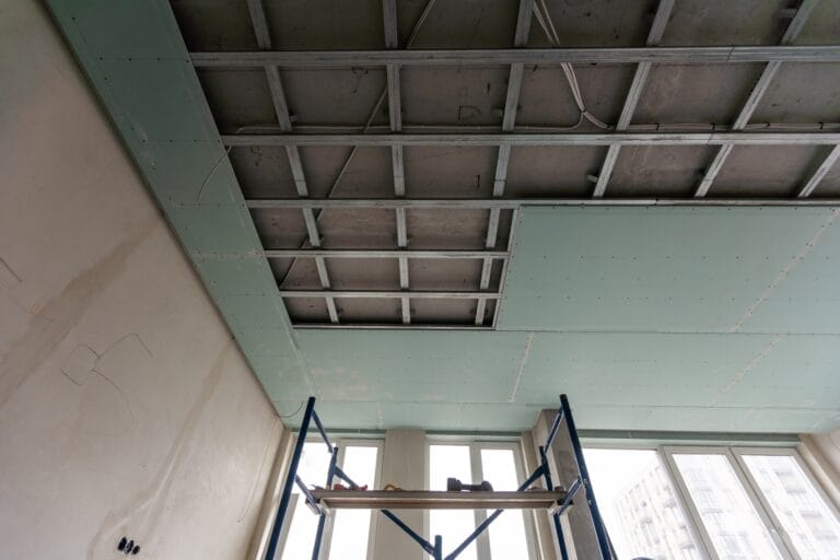 Ceiling installation with expert technicians In the room that is in the construction process drywall maintenance